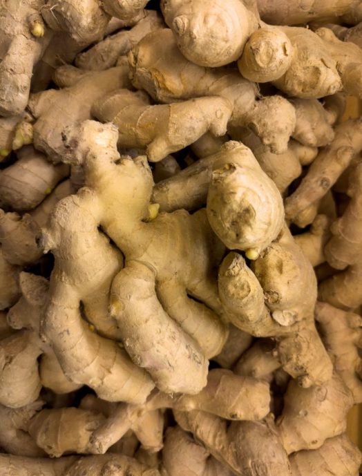 Close-up shot of fresh organic ginger roots, showcasing their textured surface, ideal for culinary and health uses.