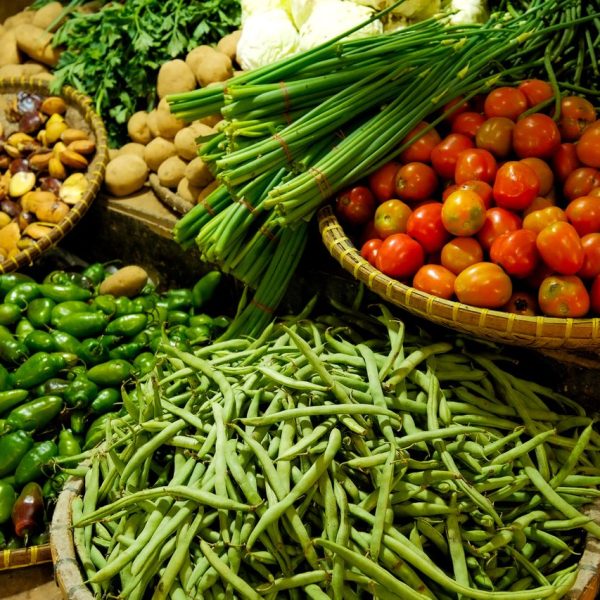 Colorful assortment of fresh vegetables in a local market setting.